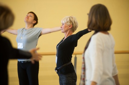Women participate in a dance therapy exercise