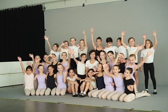 Smiling children participating in Les Grands Ballets Canadiens' The Nutcracker show
