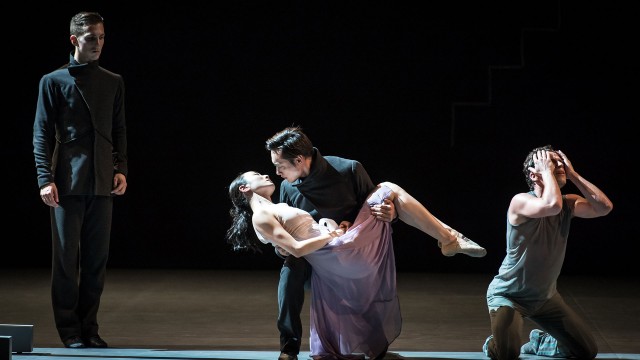 Transfigured night - dancers embracing in an artistic figure surrounded by other dancers